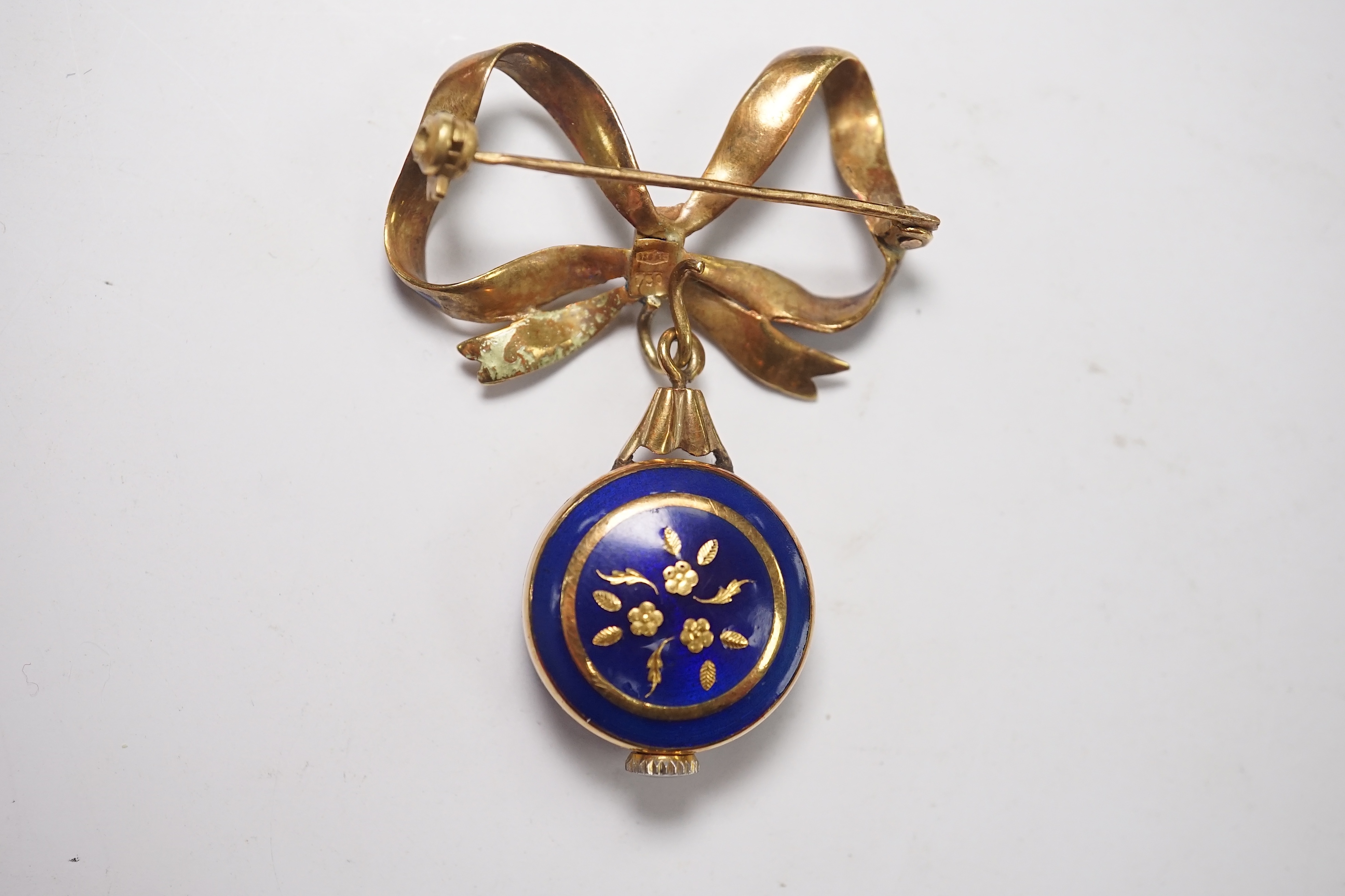 A mid 20th century Italian 750 and blue enamel fob watch, on a ribbon bow suspension brooch, overall drop 42mm, gross 10.9 grams. Condition - poor to fair